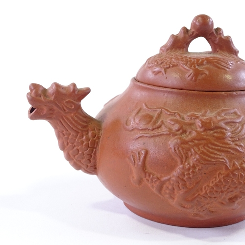 106 - A Chinese Yixing redware ceramic dragon design teapot, length 17cm