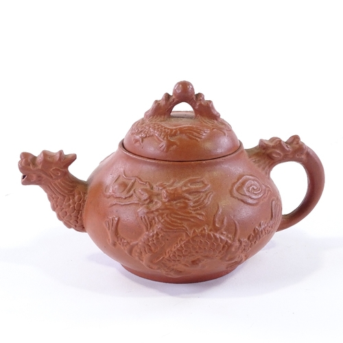 106 - A Chinese Yixing redware ceramic dragon design teapot, length 17cm