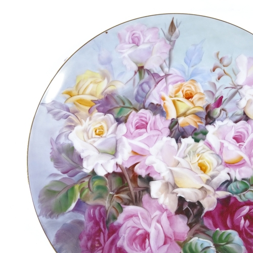 107 - A Noritake porcelain charger with hand painted rose design, signed S Kimuta, diameter 35cm