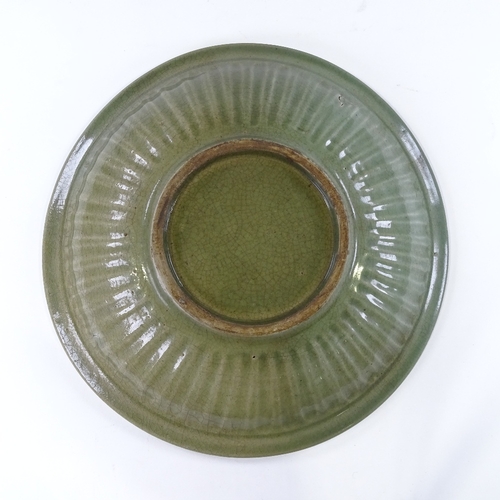 109 - A Chinese celadon green glaze porcelain table centre bowl, with relief fish designs, diameter 38cm