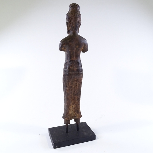 111 - An Oriental patinated bronze standing figure, overall height 46cm