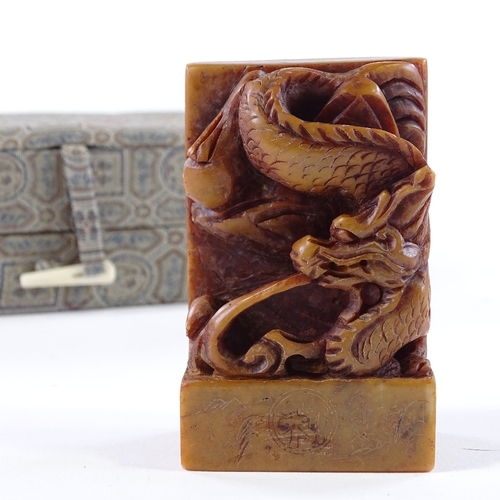 112 - A Chinese carved dragon design soapstone seal, height 7.5cm, in silk case