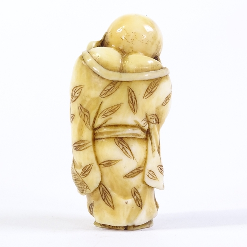 29 - A Japanese Meiji period ivory carving of a standing Hotei with whisk, height 4.5cm