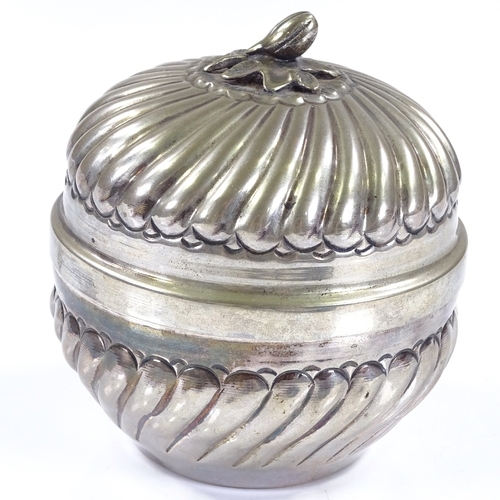 556 - A Continental circular silver lidded box, with fluted decoration and cast silver floral knop, silver... 