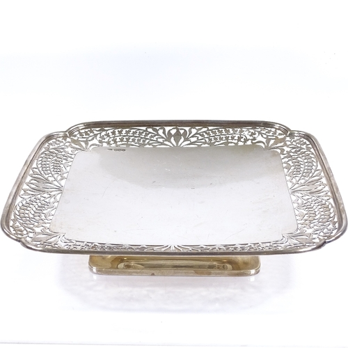 558 - A square silver cake stand, with pierced floral border, on pedestal base, by Frank Cobb & Co Ltd, ha... 