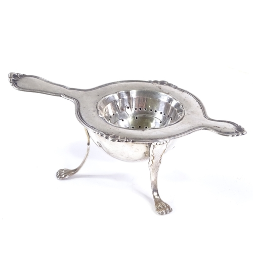 571 - A Danish silver tea strainer, with threaded rim, length 14.5cm, together with a similar silver plate... 