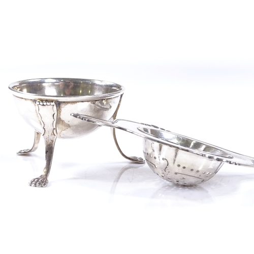 571 - A Danish silver tea strainer, with threaded rim, length 14.5cm, together with a similar silver plate... 