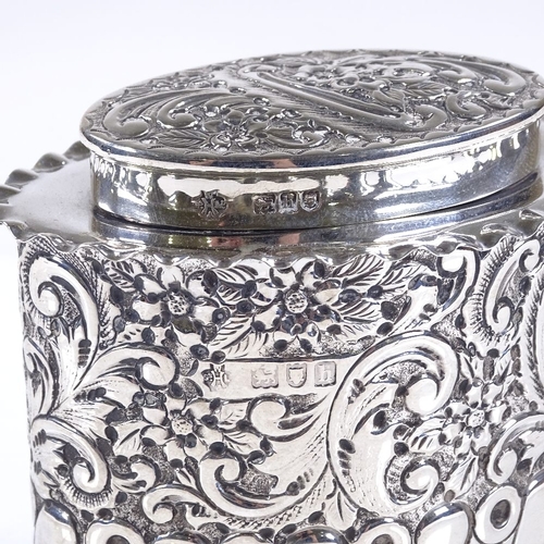 581 - A late Victorian oval silver tea caddy, of half-fluted form with relief embossed floral and scrollwo... 