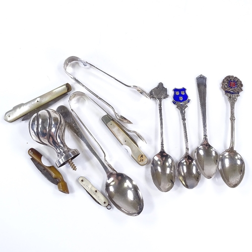 615 - Various silverware, including sugar tongs, teaspoons, and fruit knives