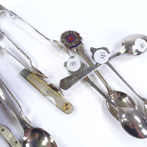 615 - Various silverware, including sugar tongs, teaspoons, and fruit knives