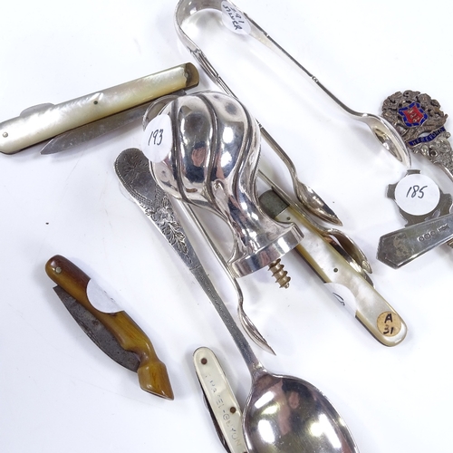 615 - Various silverware, including sugar tongs, teaspoons, and fruit knives