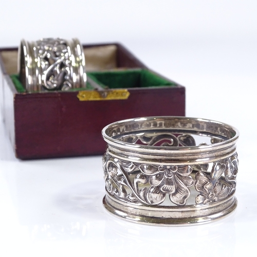 622 - A pair of Edwardian Art Nouveau silver napkin rings, with pierced floral decoration, 1 by Marples & ... 