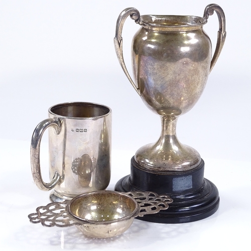 625 - A silver 2-handled trophy on stand, silver tea strainer, and silver christening mug, 6.3oz weighable... 