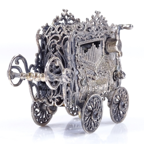 646 - An unusual novelty silver plated miniature music box, in the form of a carriage, length 7cm