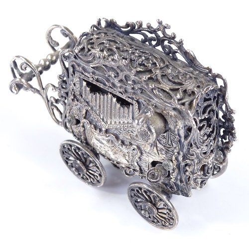 646 - An unusual novelty silver plated miniature music box, in the form of a carriage, length 7cm