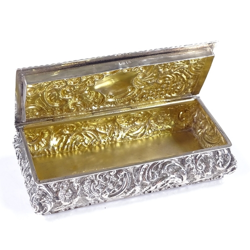 653 - A late Victorian rectangular silver snuffbox, with relief embossed foliate decoration, by William Ne... 