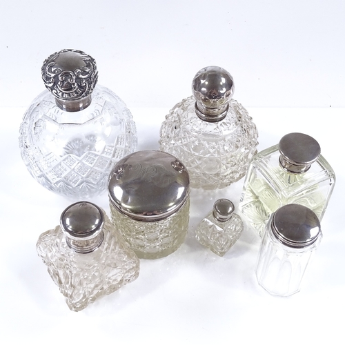 658 - 7 silver-topped dressing table jars