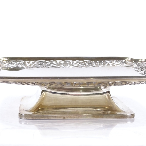 558 - A square silver cake stand, with pierced floral border, on pedestal base, by Frank Cobb & Co Ltd, ha... 