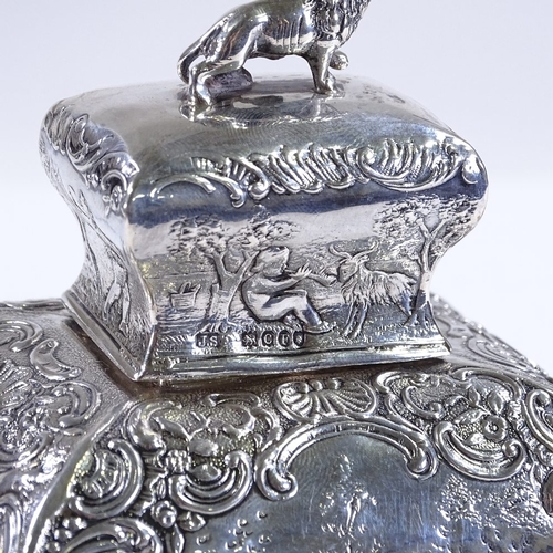 565 - A 19th century French silver tea caddy, of rectangular baluster form, with relief embossed lover sce... 