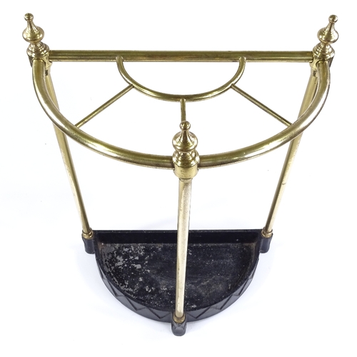 107 - A Victorian brass semi-circular stick stand, on painted metal base