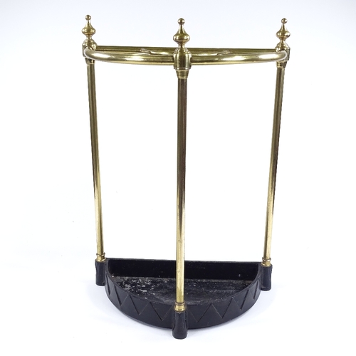 107 - A Victorian brass semi-circular stick stand, on painted metal base