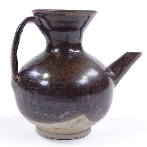 119 - A Chinese dark brown glaze jar with spout, height 11cm