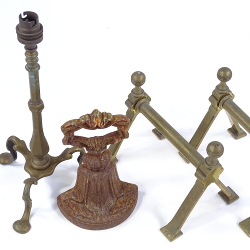 127 - A Victorian cast-iron doorstop, a pair of Benham & Froud fire dogs, and a brass lamp