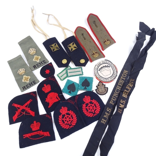 36 - A collection of military cloth badges, epaulettes etc, including Navy cap bands from HMS Belfast, HM... 