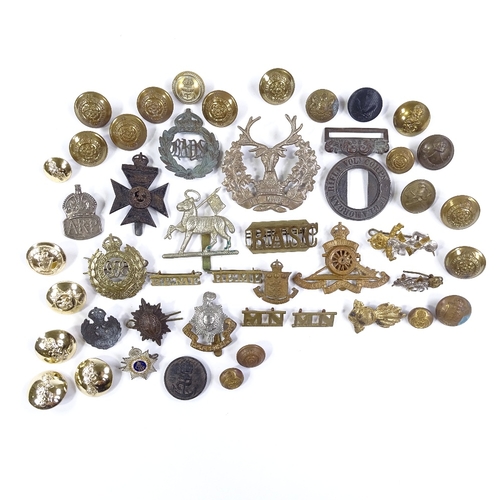 37 - A collection of military cap badges and buttons