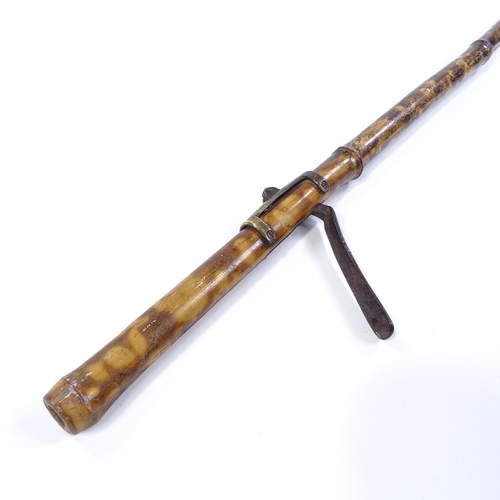47 - A Victorian brass-mounted bamboo mechanical long-arm grip, length 98cm