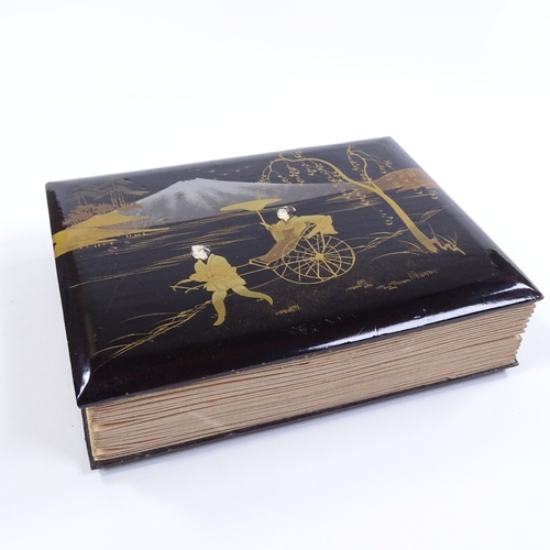 50 - A Japanese gilded and lacquered album, containing early 20th century postcards and scraps, album siz... 