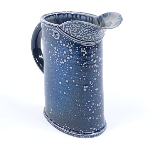 60 - Walter Keeler (British born 1942), a blue salt glaze leaning jug, height 17cm
