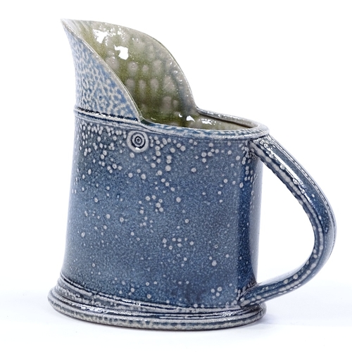 62 - Walter Keeler (British born 1942), a blue salt glaze leaning jug, height 16cm