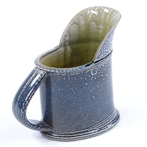 62 - Walter Keeler (British born 1942), a blue salt glaze leaning jug, height 16cm