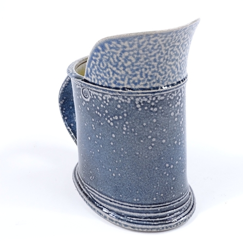 62 - Walter Keeler (British born 1942), a blue salt glaze leaning jug, height 16cm