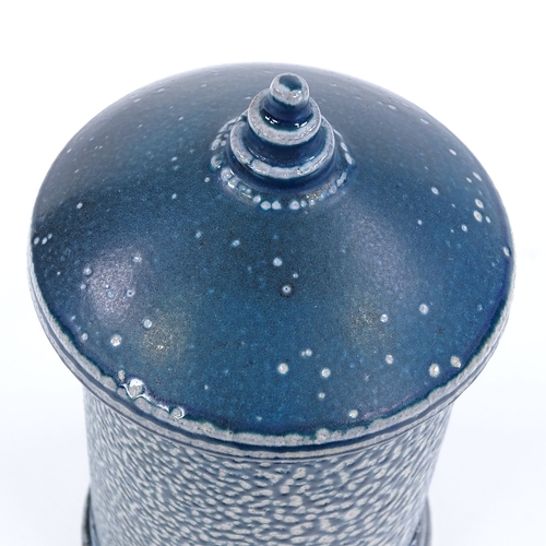 63 - Walter Keeler (British born 1942), a blue salt glaze leaning storage jar and cover, height 17cm