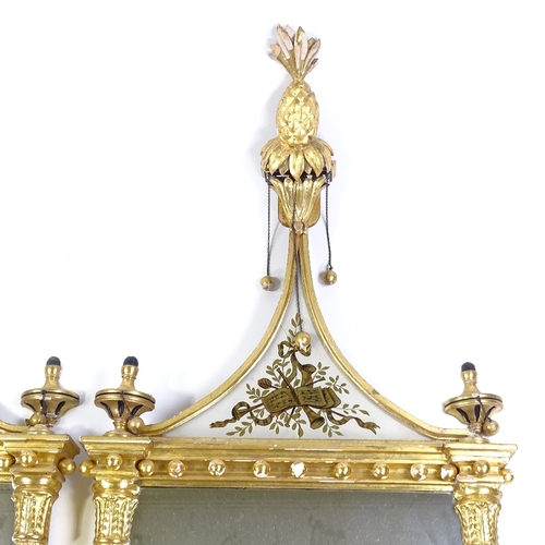 70 - A pair of Italian carved and gilded gesso-framed wall mirrors, with gilded verre eglomise inset pedi... 