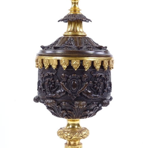 84 - A modern patinated and parcel gilt-bronze table lamp, with relief moulded Classical designs, height ... 