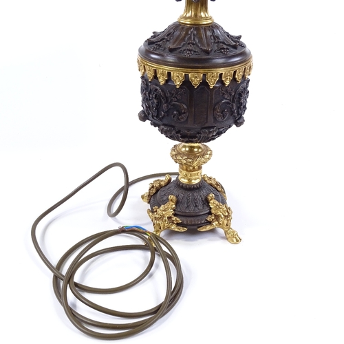 84 - A modern patinated and parcel gilt-bronze table lamp, with relief moulded Classical designs, height ... 