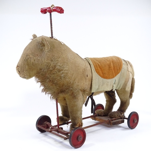 122 - An Antique Steiff straw-filled ride-on soft toy lion, with growler, length 50cm