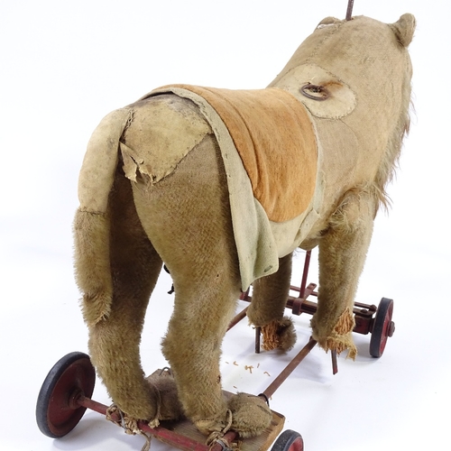 122 - An Antique Steiff straw-filled ride-on soft toy lion, with growler, length 50cm