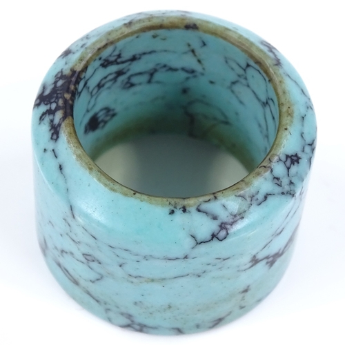 128 - A polished turquoise archer's ring, diameter 32cm