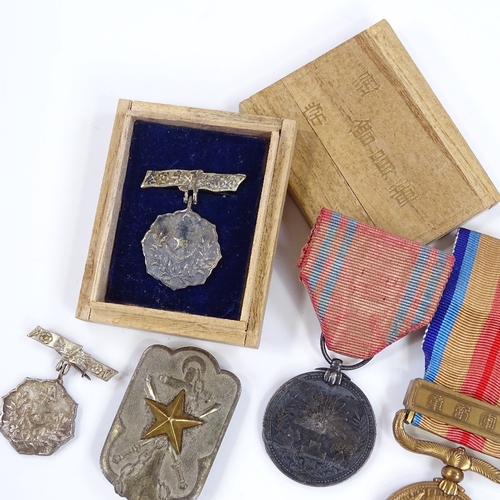 137 - 6 Second War Period Japanese medals, and a Japanese Navy badge