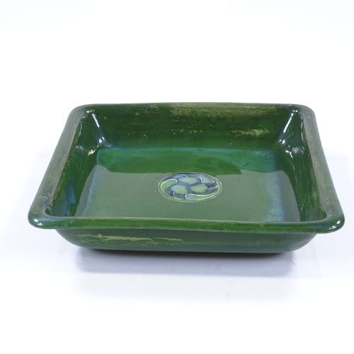 17 - A Moorcroft Flamminian Ware square bowl, with green glaze and stylised central panel, 24cm across