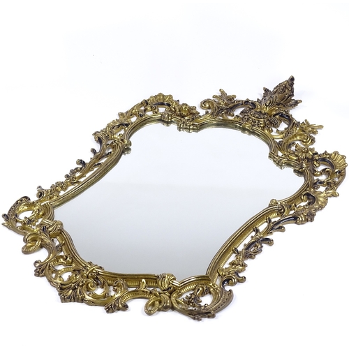 175 - An ornate cast and pierced gilt-brass framed wall mirror, height 105cm (41