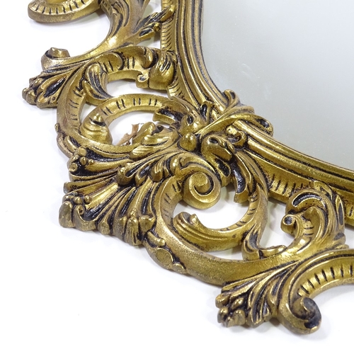 175 - An ornate cast and pierced gilt-brass framed wall mirror, height 105cm (41