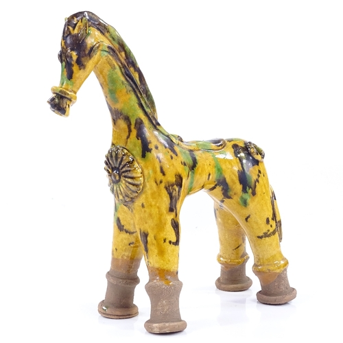 180 - A Turkish yellow glaze Canakkale pottery horse, height 23cm