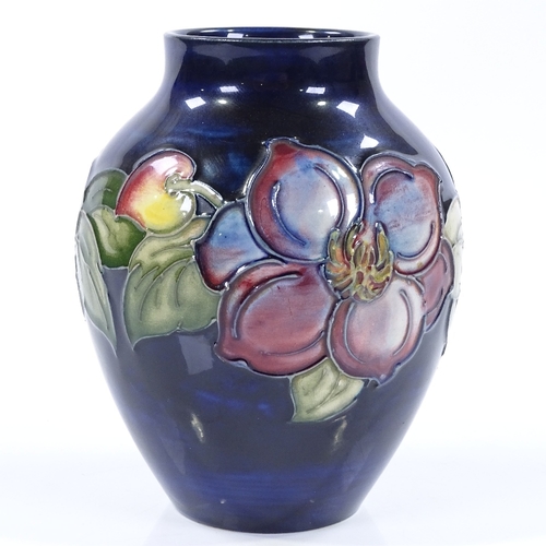 19 - A Moorcroft blue ground Anemone pattern vase, height 12cm