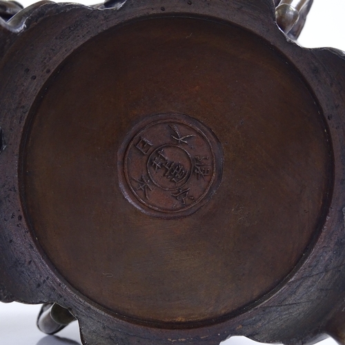 199 - A pair of Oriental patinated bronze vases and covers, with Dog of Fo knops and bird decorated relief... 