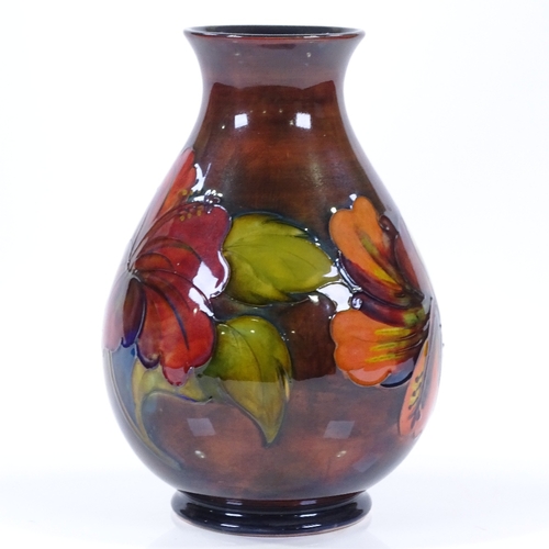 23 - A Moorcroft flambe Hibiscus pattern vase, original label under base, height 21cm